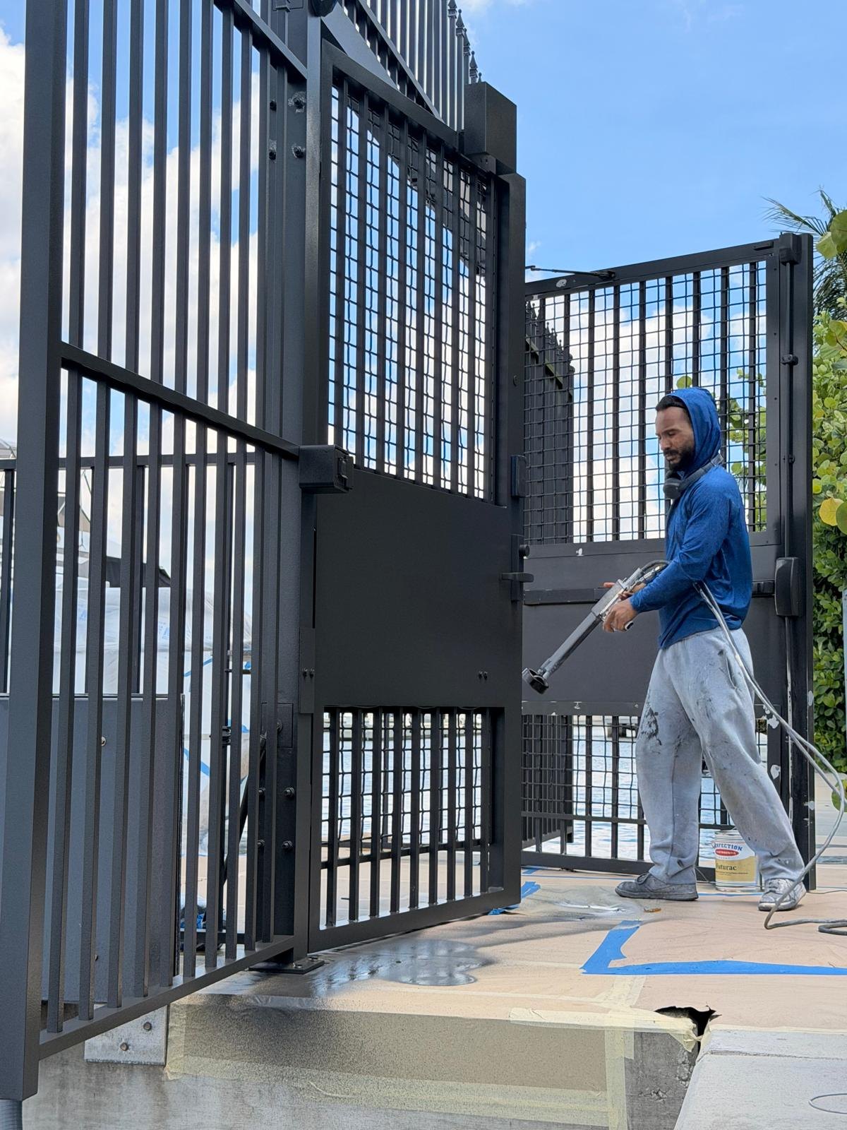 Electrostatic painting of an installed metal gate at a South Florida marina
