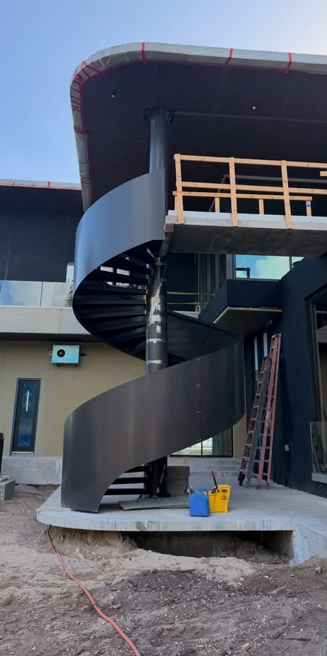 Finished metal spiral staircase after professional coating in South Florida