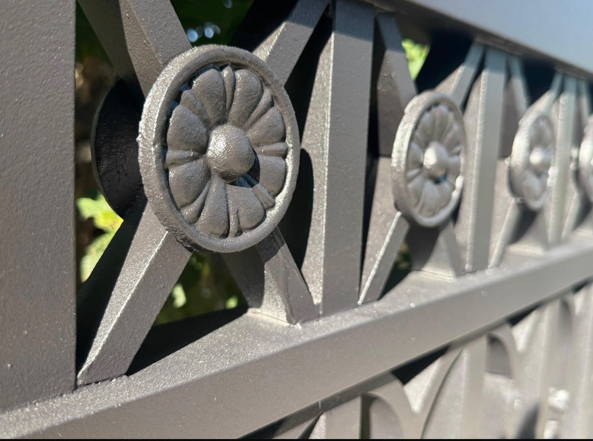 Restored ornamental metal fence with smooth professional coating finish