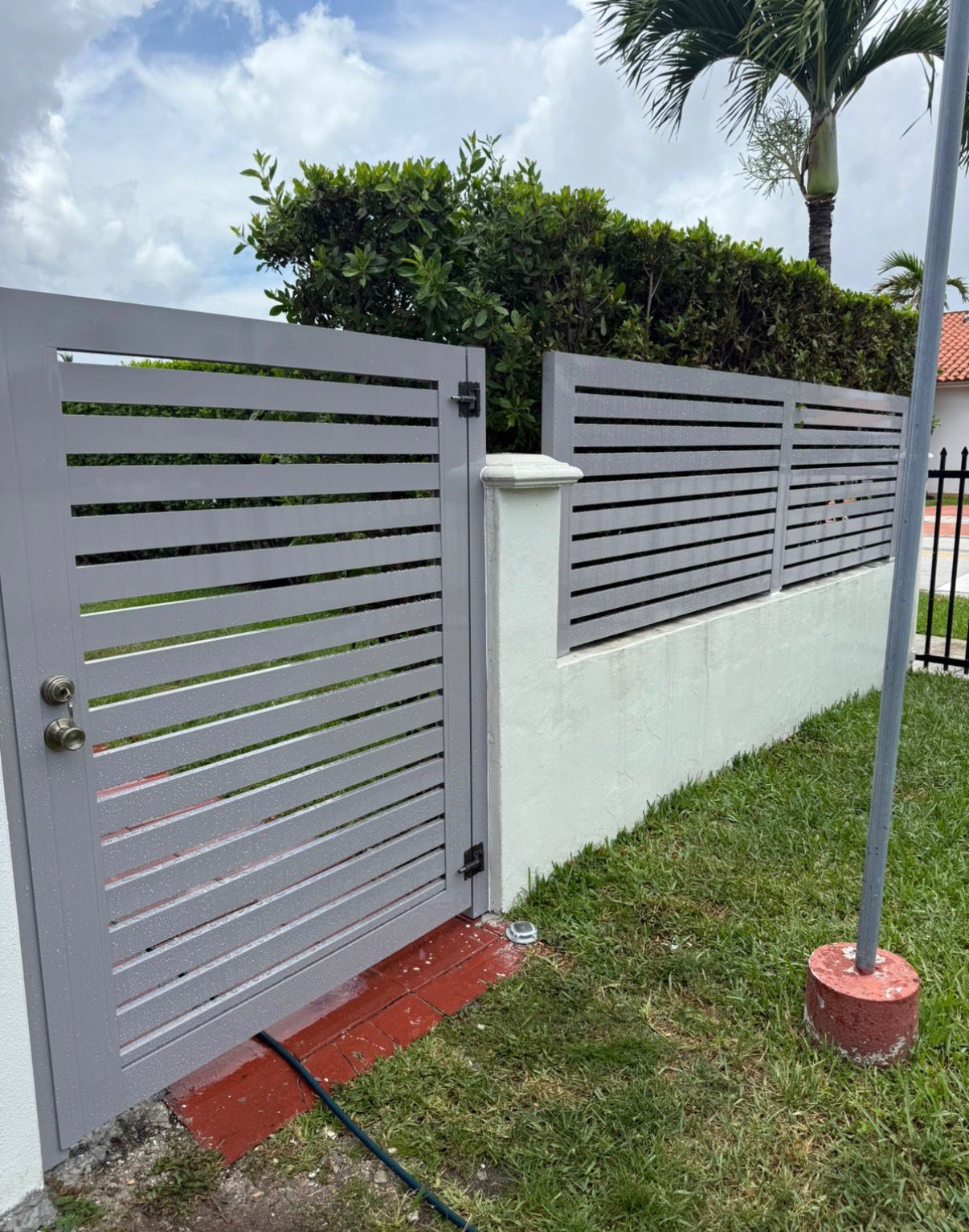 Metal gate before restoration showing worn and failing coating