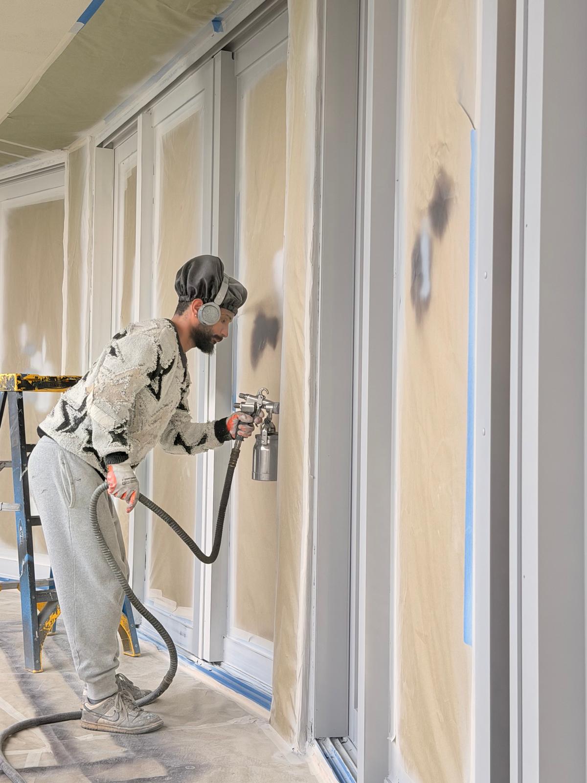 Spray application of coating on an installed aluminum frame with glass masked off